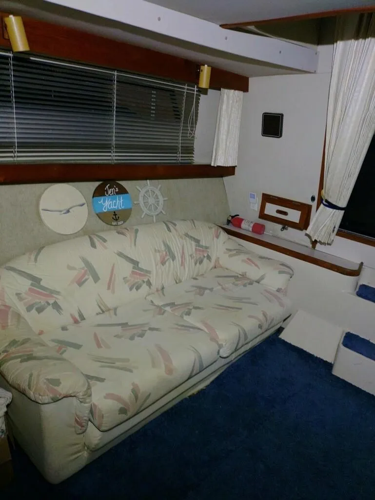 Slide: The Image of Interior of 1988 Carver Mariner 32 with patterned sofa and nautical decor. - 22