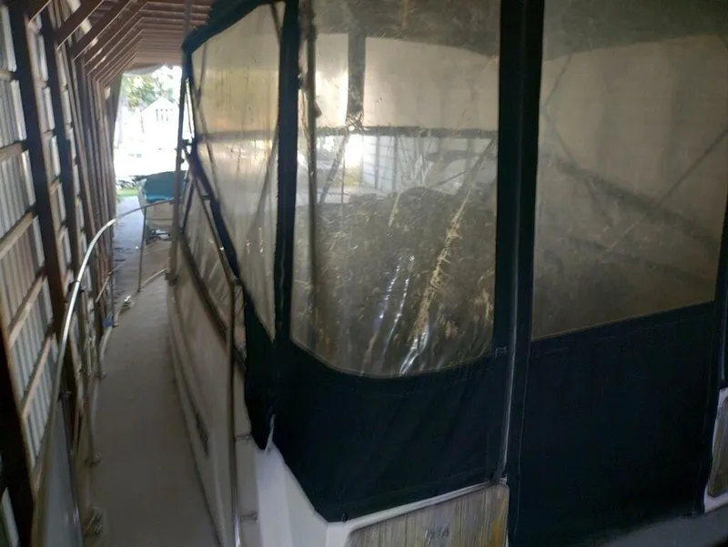 Slide: The Image of 1988 Carver Mariner 32 boat docked in a covered marina. - 4