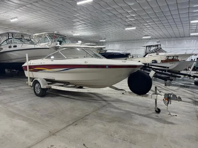 Slide: The Image of 2001 Bayliner Capri 195 LX boat on trailer in indoor storage facility. - 0