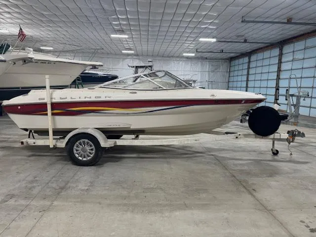 Slide: The Image of 2001 Bayliner Capri 195 LX boat on trailer in indoor storage facility. - 1