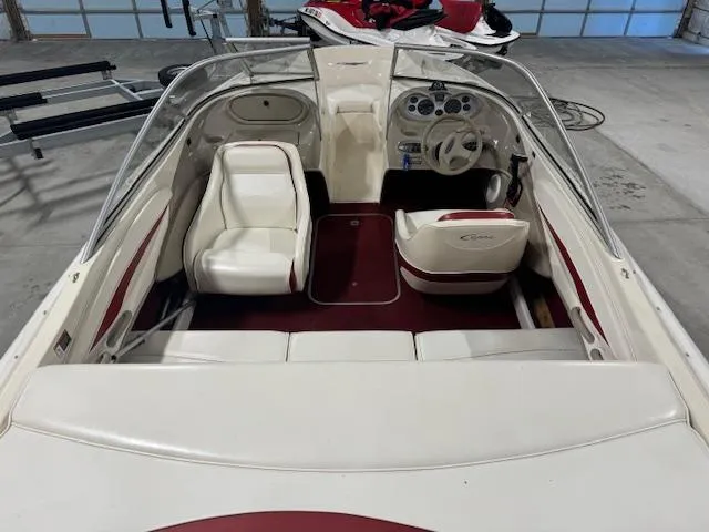Slide: The Image of 2001 Bayliner Capri 195 LX interior with white and red seating, steering wheel, and dashboard. - 11