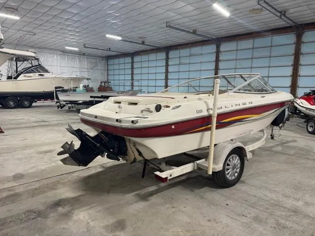 Slide: The Image of 2001 Bayliner Capri 195 LX boat on trailer in indoor storage facility. - 2