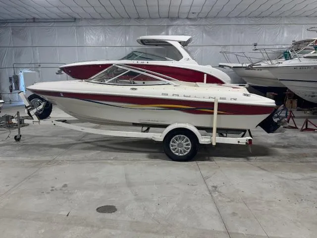 Slide: The Image of 2001 Bayliner Capri 195 LX boat on trailer in indoor storage facility. - 3