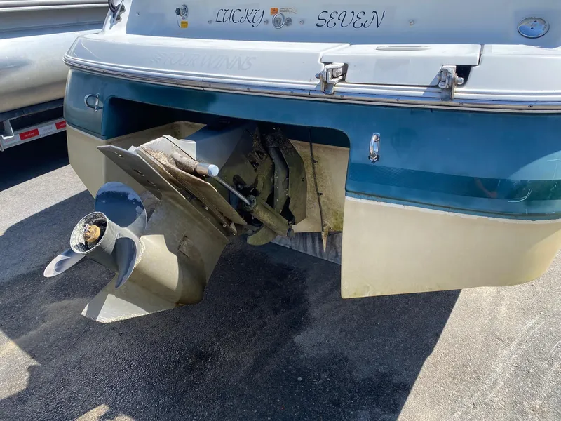 Slide: The Image of 2002 Four Winns 225 Sundowner boat stern with visible propeller and outdrive. - 5