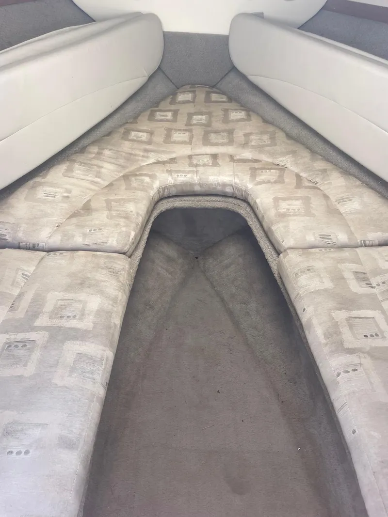 Slide: The Image of 2002 Four Winns 225 Sundowner cabin interior with patterned upholstery and spacious seating. - 9