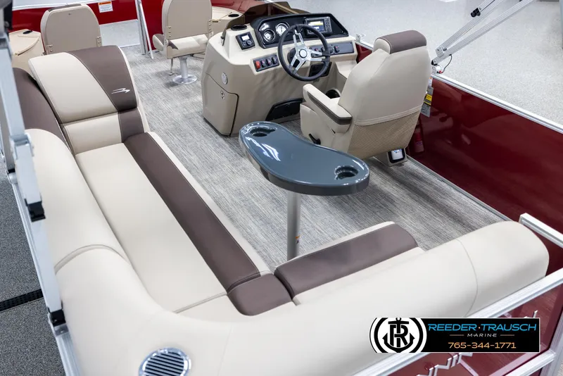 Slide: The Image of 2025 Bennington 188 SSSE pontoon boat interior with beige and brown seating, modern dashboard. - 11