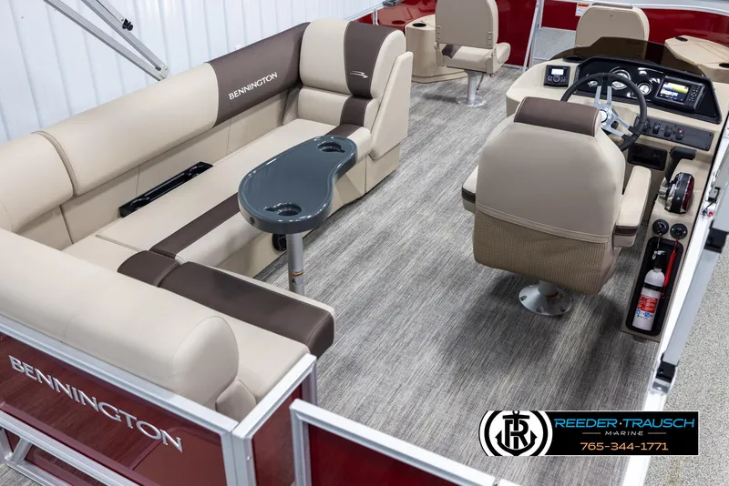 Slide: The Image of 2025 Bennington 188 SSSE pontoon boat interior with beige seating and modern dashboard. - 12