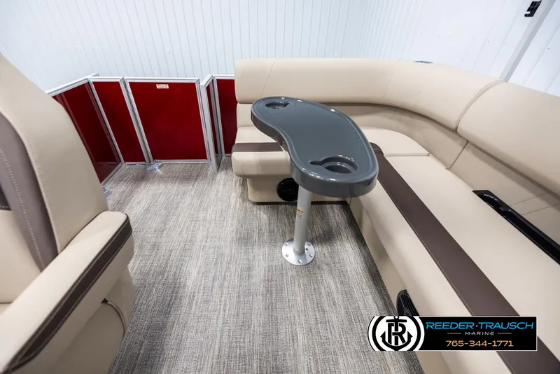 Slide: The Image of 2025 Bennington 188 SSSE boat interior with beige seating and a central table. - 15