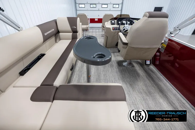 Slide: The Image of 2025 Bennington 188 SSSE boat interior with beige seating and steering console. - 16
