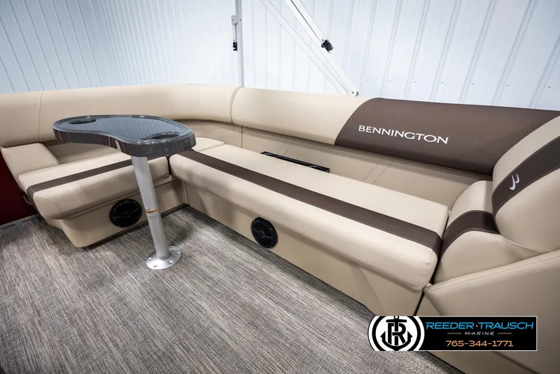 Slide: The Image of 2025 Bennington 188 SSSE boat interior with beige seating and table. - 25