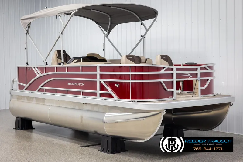 Slide: The Image of 2025 Bennington 188 SSSE pontoon boat with red exterior and canopy in showroom. - 3