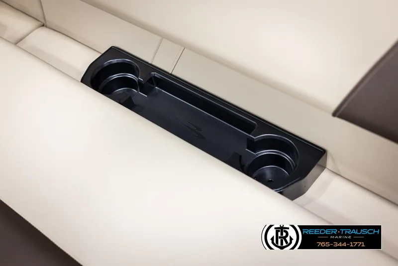Slide: The Image of 2025 Bennington 188 SSSE boat interior with cup holders and beige seating. - 39