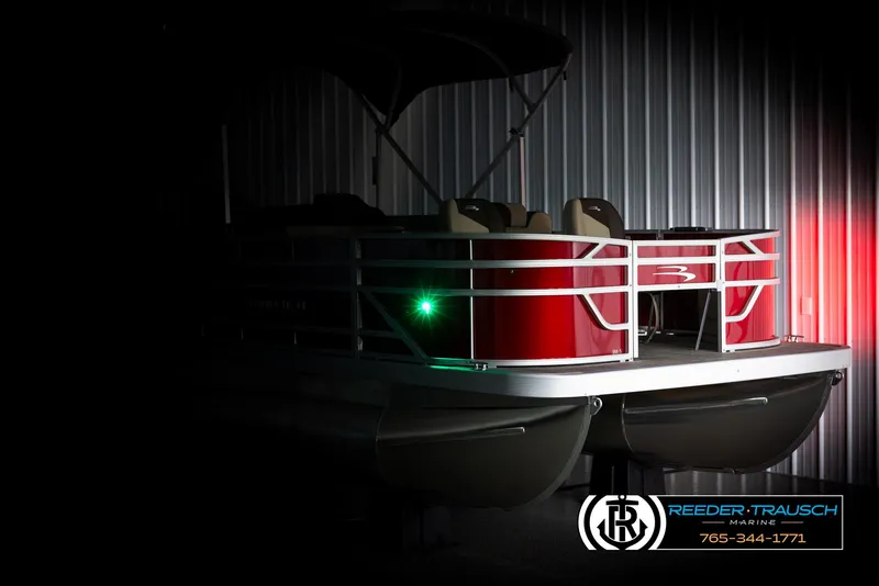 Slide: The Image of 2025 Bennington 188 SSSE pontoon boat in dimly lit storage. - 4