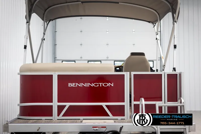 Slide: The Image of 2025 Bennington 188 SSSE pontoon boat with red exterior and canopy in showroom. - 7