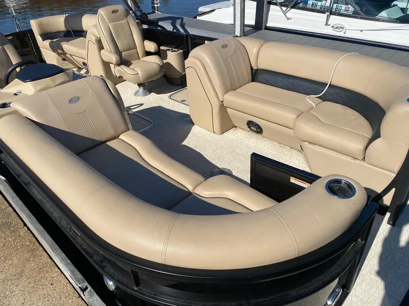 Slide: The Image of 2019 Barletta E22QC pontoon boat with luxurious beige seating and spacious interior. - 2