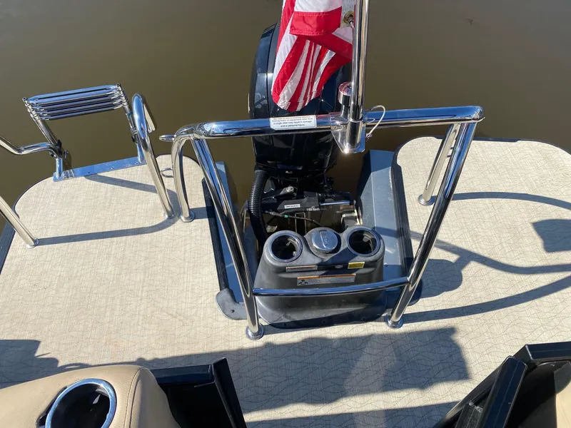 Slide: The Image of 2019 Barletta E22QC boat deck with motor and American flag. - 5