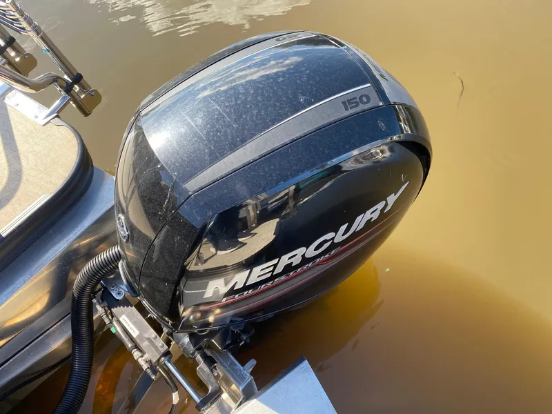 Slide: The Image of Mercury 150 outboard motor on 2019 Barletta E22QC boat in water. - 6