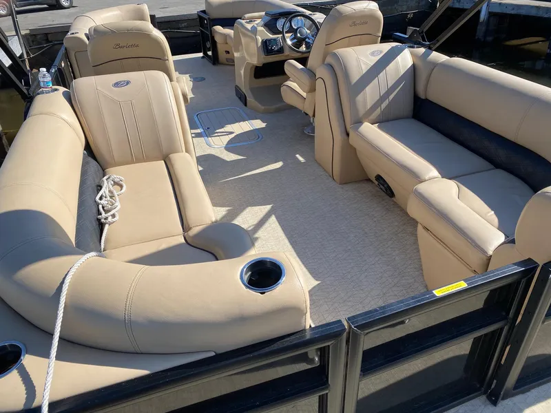 Slide: The Image of 2019 Barletta E22QC pontoon boat with beige seating and spacious interior. - 7