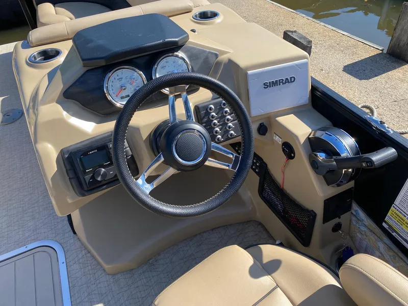 Slide: The Image of 2019 Barletta E22QC boat dashboard with steering wheel and Simrad display. - 8