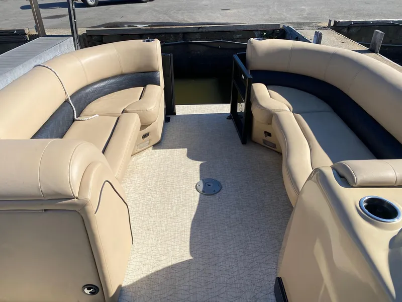 Slide: The Image of 2019 Barletta E22QC pontoon boat interior with beige seating and spacious layout. - 9