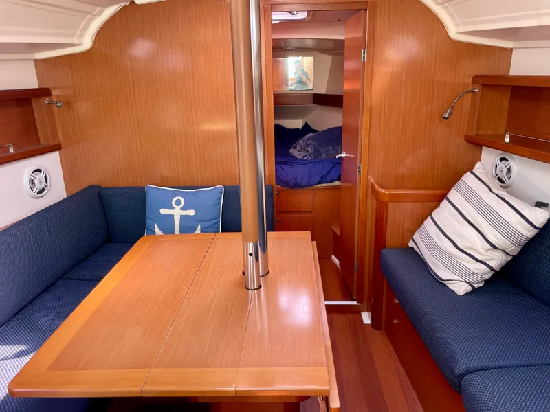 Slide: The Image of Interior of 2010 Beneteau Oceanis 37 sailboat with cozy seating and wooden finishes. - 11