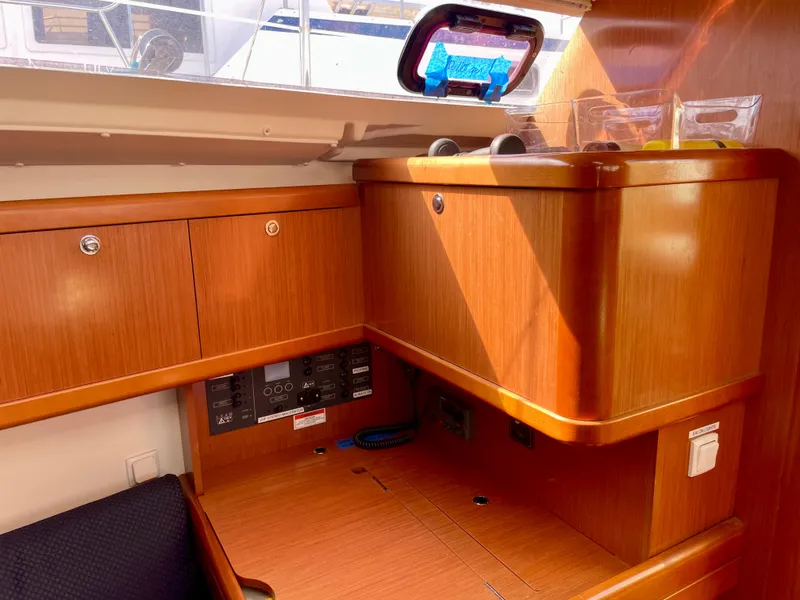 Slide: The Image of Interior of 2010 Beneteau Oceanis 37 yacht with wooden cabinetry and control panel. - 19