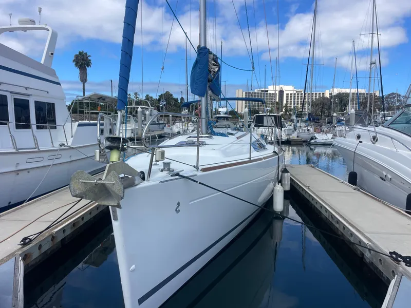 Slide: The Image of Beneteau Oceanis 37 sailboat docked in marina, 2010 model, clear sky background. - 2