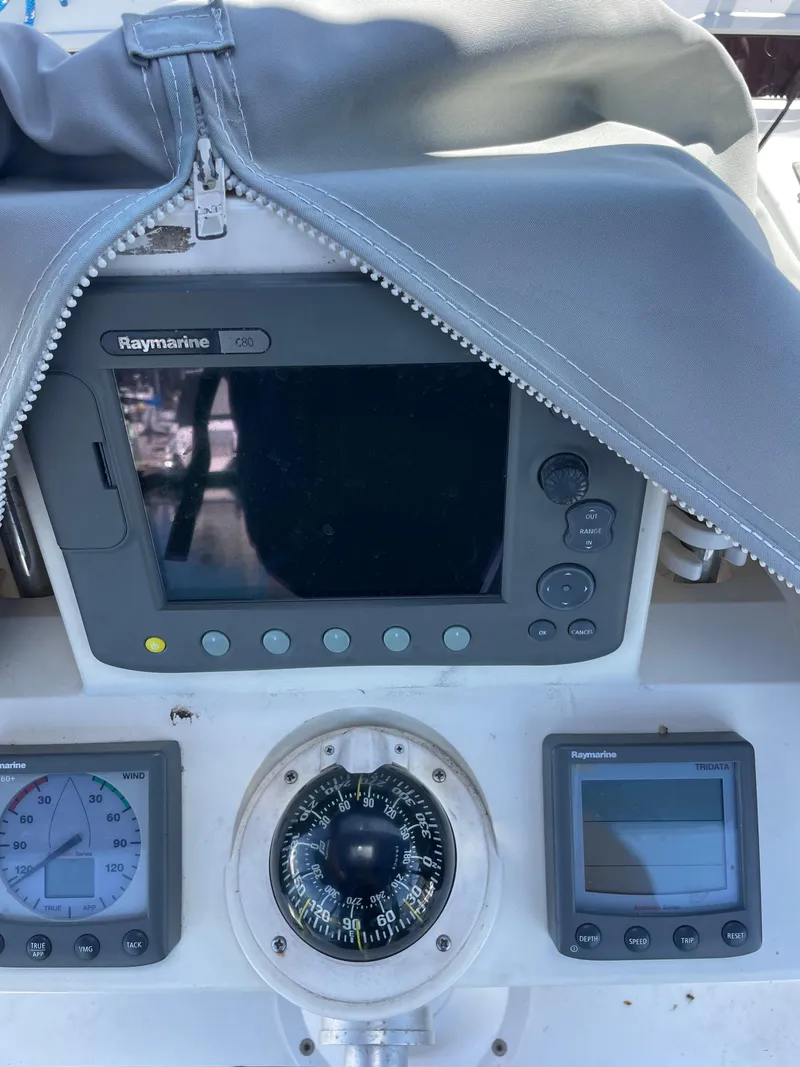 Slide: The Image of Beneteau Oceanis 37 cockpit instruments, featuring Raymarine displays and compass, 2010 model. - 27