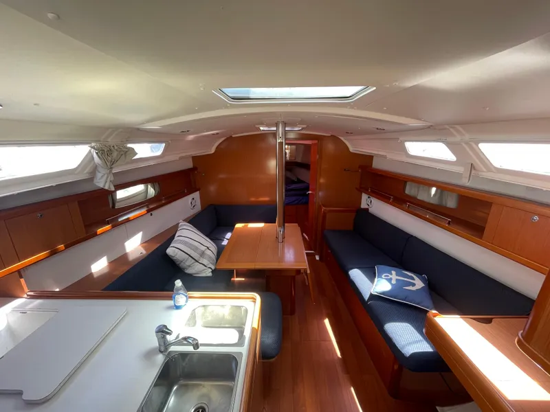 Slide: The Image of Interior of 2010 Beneteau Oceanis 37 sailboat with cozy seating and dining area. - 28