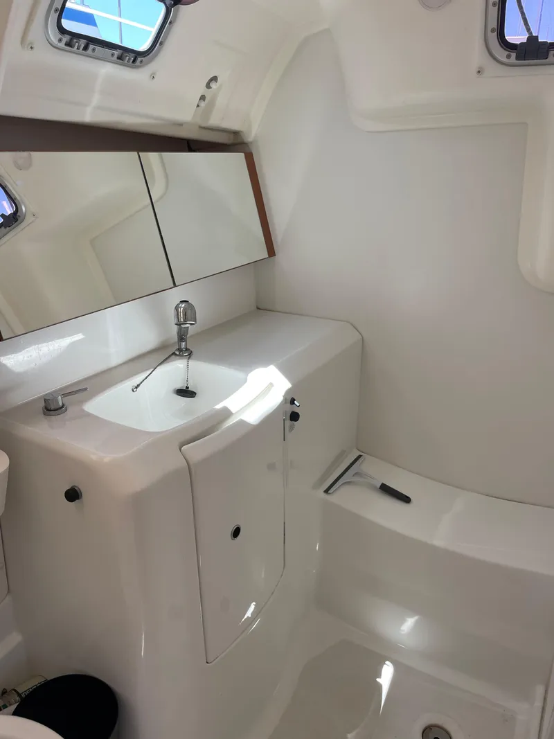 Slide: The Image of Beneteau Oceanis 37 bathroom interior, 2010 model, featuring a sleek sink and mirror. - 30
