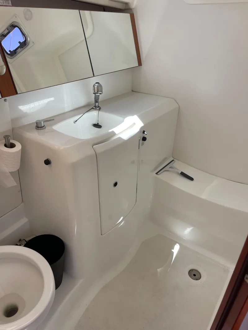 Slide: The Image of 2010 Beneteau Oceanis 37 bathroom with sink, mirror, and toilet. - 31
