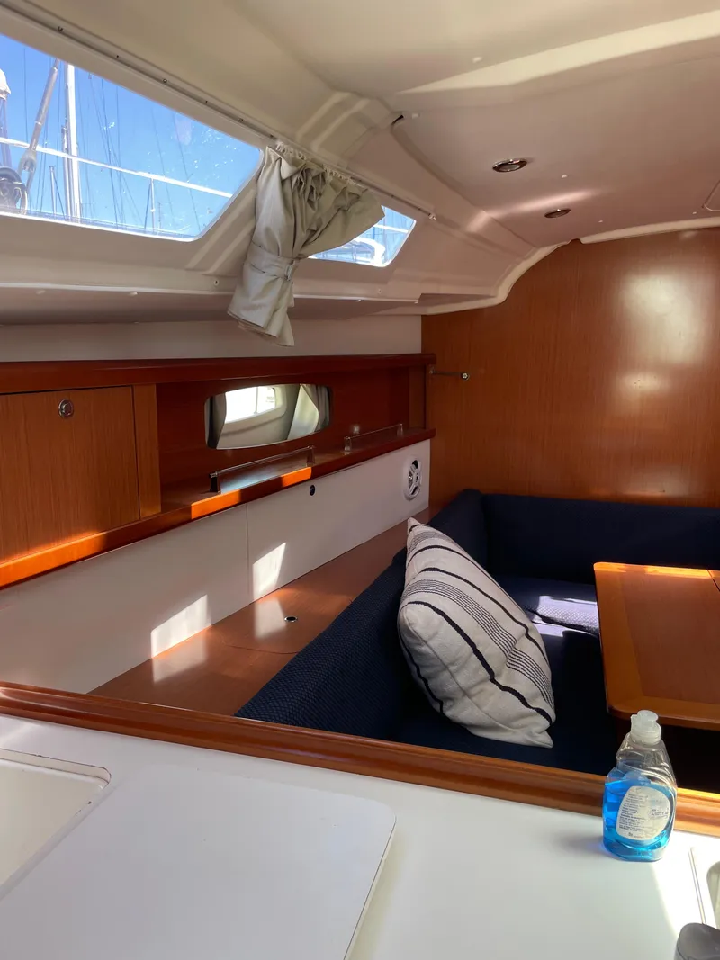 Slide: The Image of Interior of 2010 Beneteau Oceanis 37 sailboat with wooden finish and seating area. - 33