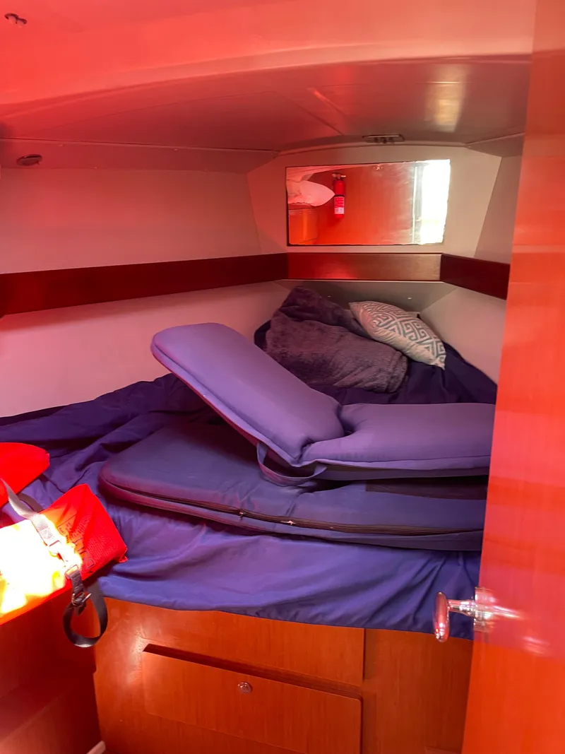 Slide: The Image of Cozy cabin interior of 2010 Beneteau Oceanis 37 sailboat with blue bedding. - 35