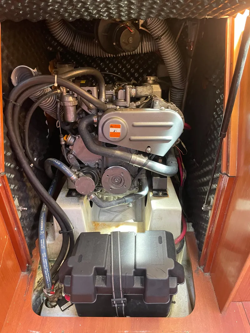Slide: The Image of Engine compartment of a 2010 Beneteau Oceanis 37 sailboat, showcasing mechanical components and wiring. - 36