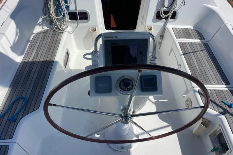 Slide: The Image of Cockpit of 2010 Beneteau Oceanis 37 sailboat with steering wheel and navigation instruments. - 40