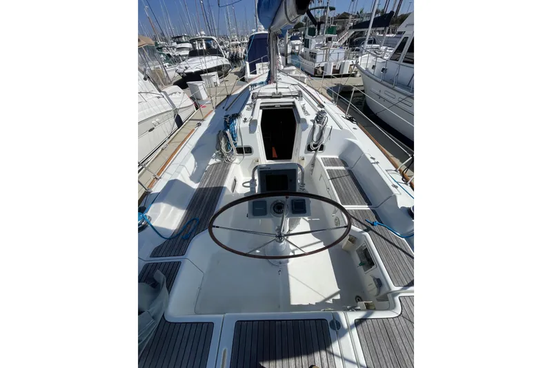 Slide: The Image of 2010 Beneteau Oceanis 37 sailboat cockpit with steering wheel, docked at marina. - 41