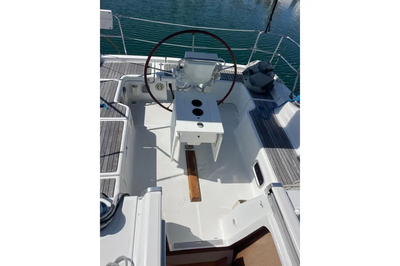Slide: The Image of Cockpit of 2010 Beneteau Oceanis 37 sailboat with steering wheel and seating. - 42
