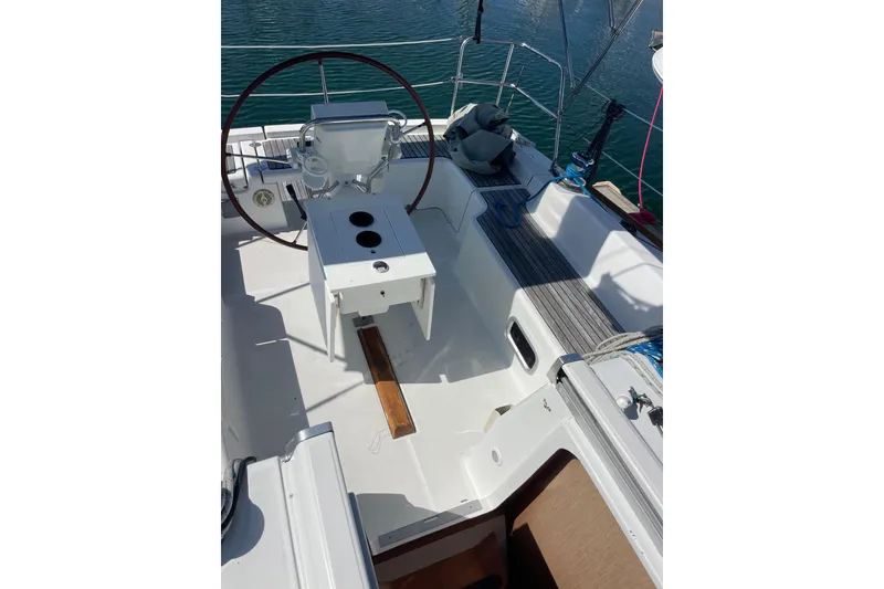 Slide: The Image of 2010 Beneteau Oceanis 37 sailboat cockpit with steering wheel and seating area. - 44