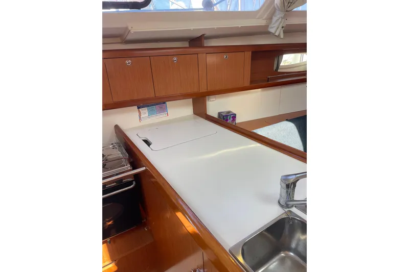 Slide: The Image of Interior of 2010 Beneteau Oceanis 37 yacht kitchen with wooden cabinets and sink. - 45