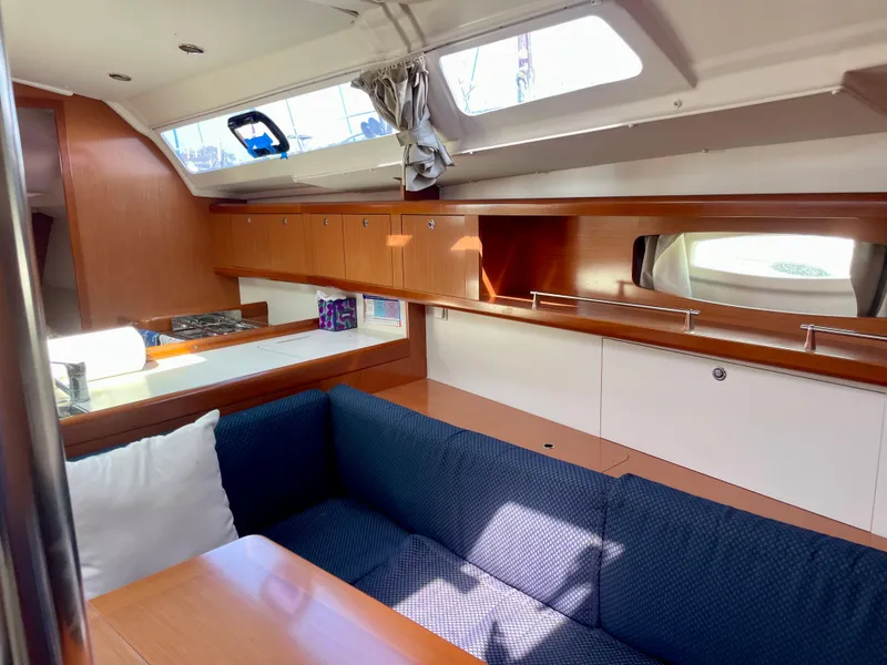 Slide: The Image of Interior of 2010 Beneteau Oceanis 37 sailboat with wood finish and blue seating. - 5