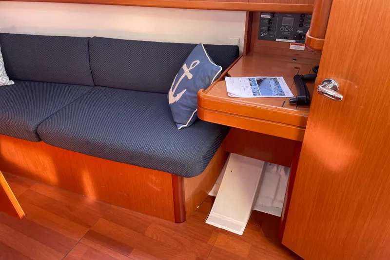 Slide: The Image of Interior of 2010 Beneteau Oceanis 37 yacht with blue seating and navigation desk. - 50