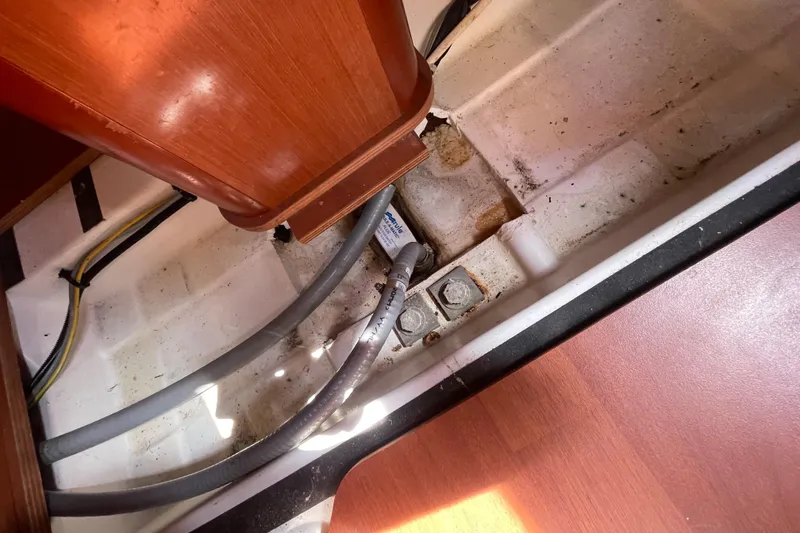 Slide: The Image of Interior view of a 2010 Beneteau Oceanis 37 sailboat, showing wiring and structural components. - 54