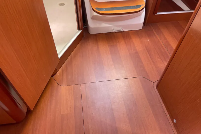 Slide: The Image of Interior of 2010 Beneteau Oceanis 37 yacht with wooden flooring and open door. - 57