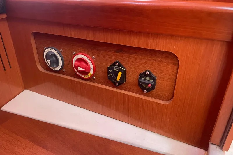 Slide: The Image of Control panel on 2010 Beneteau Oceanis 37 yacht with switches and circuit breakers. - 59