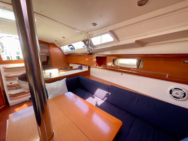 Slide: The Image of Interior of 2010 Beneteau Oceanis 37 sailboat with cozy seating and wooden finishes. - 6