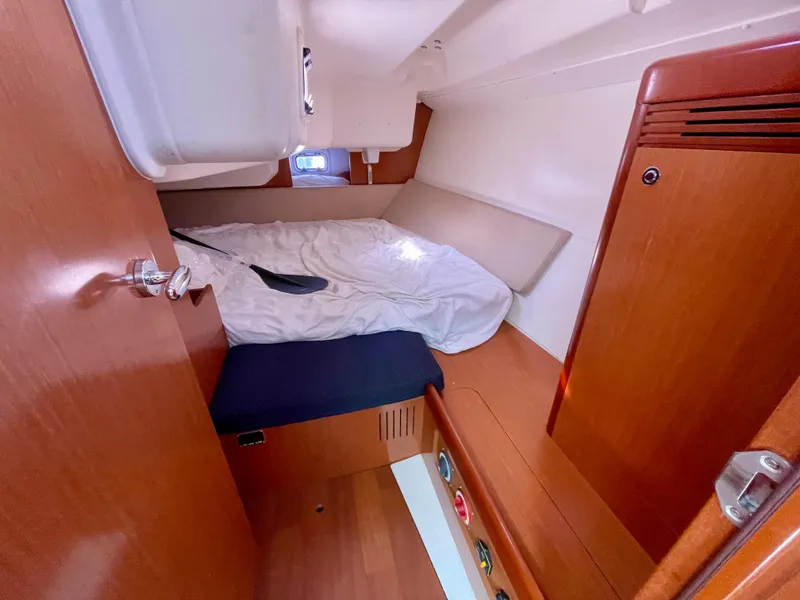 Slide: The Image of Cozy cabin interior of 2010 Beneteau Oceanis 37 sailboat with wooden finish and bedding. - 9