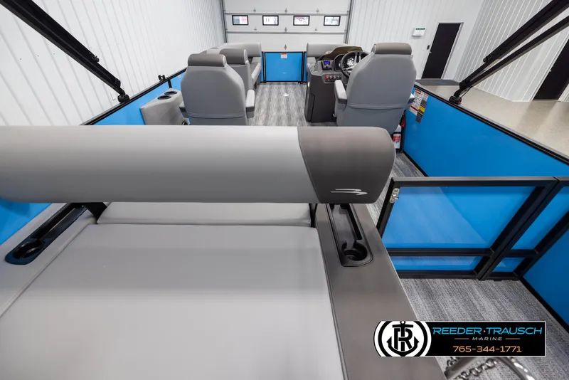 Slide: The Image of 2025 Bennington 23 SSBSE pontoon boat interior with gray seating and blue accents. - 16