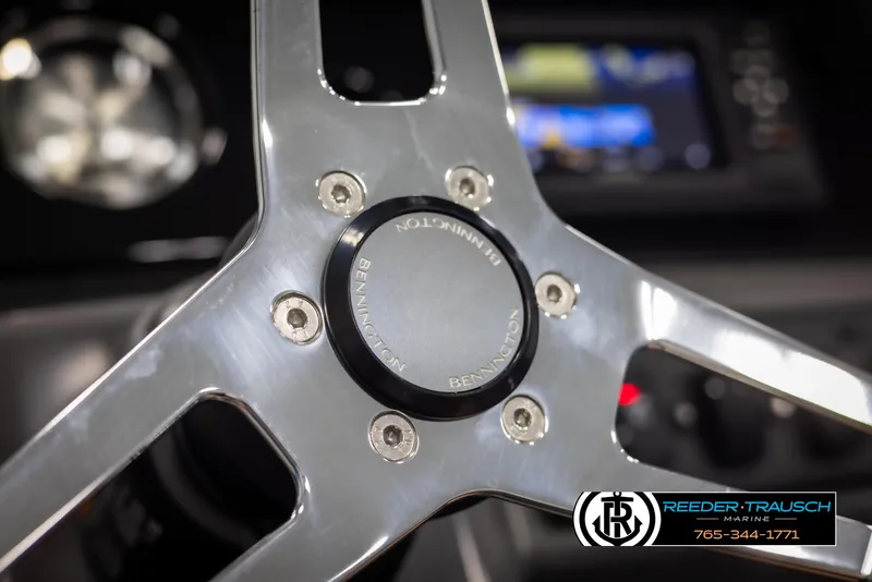 Slide: The Image of Close-up of 2025 Bennington 23 SSBSE steering wheel with Reeder-Trausch Marine logo. - 25