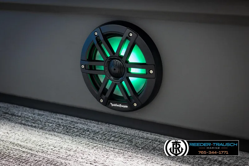 Slide: The Image of 2025 Bennington 23 SSBSE boat speaker with green LED lighting, Reeder-Trausch Marine branding. - 36