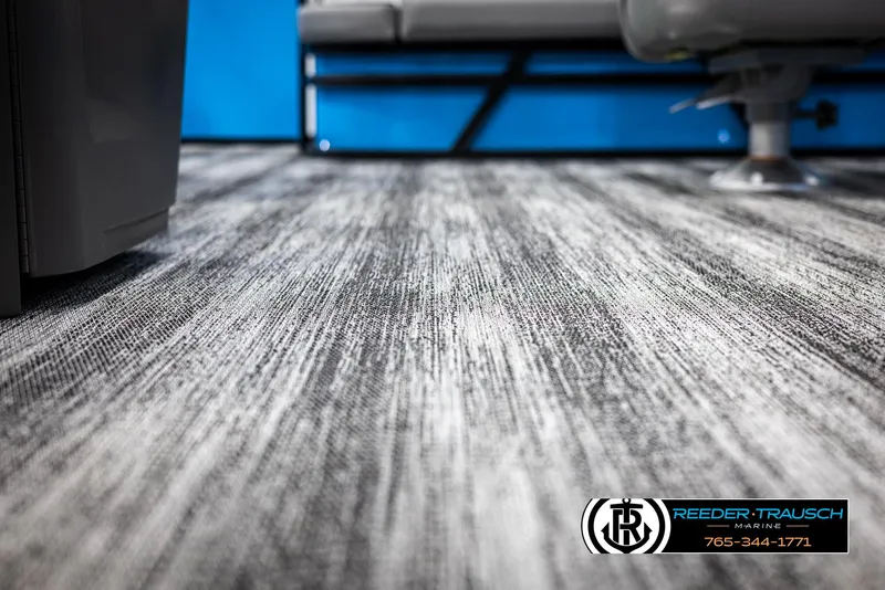 Slide: The Image of 2025 Bennington 23 SSBSE boat interior with textured flooring and seating. - 39